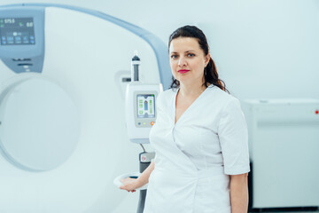 Smiling confident radiologist and MRI Scanner.