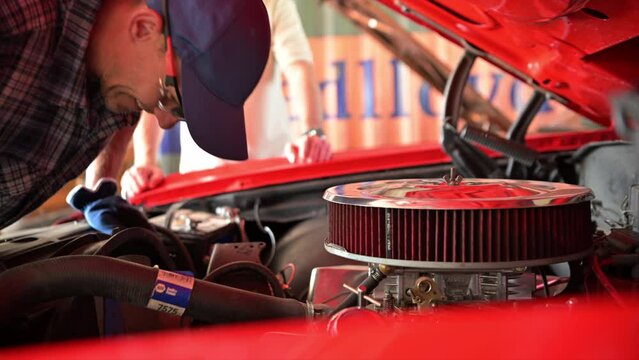 Car Mechanic Working on Classic Car Engine Air Filter