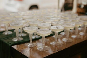Table filled with multiple champagne glasses ready for a celebration event