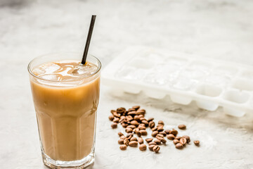 iced coffee with beans for cold summer drink on stone background