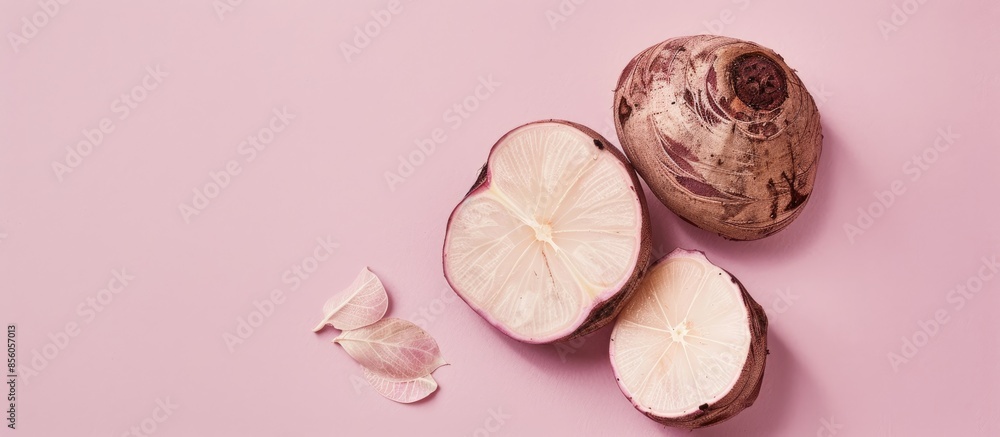 Poster whole and half taro root with leaf isolated on pastel background. with copy space image. place for a