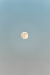 full moon over the sea with with clear sky during a sunset golden hour © Hanjin
