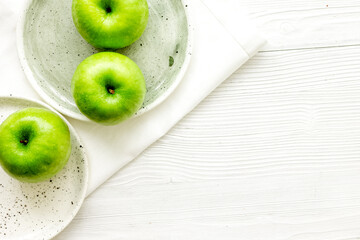 Healthy green food with apples on plates white background top view mock up