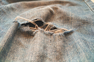 Clothes with a torn part, wear and tear of things, designer trends in fashion, the style of scum...