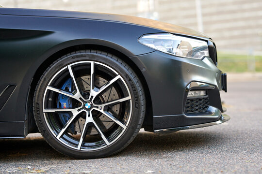Minsk, Belarus. May 3, 2024. BMW M5 F90 Competition on parking lot, front view. BMW M5 front wheel and brake disc closeup. Michelin Pilot Sport 4 S tire, advanced design, high-performance capabilities