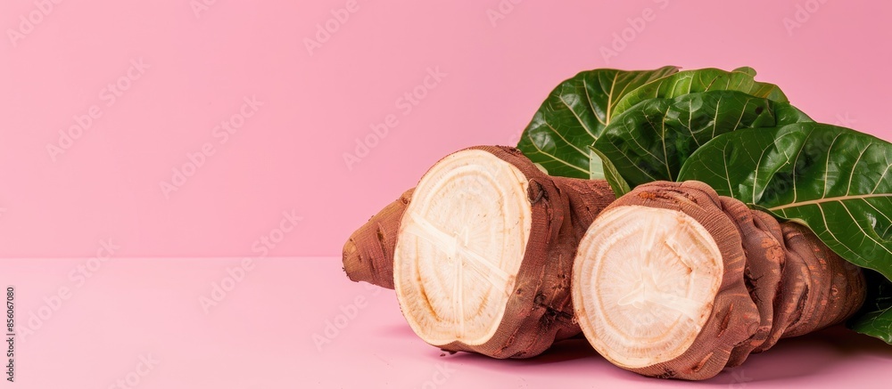Aufkleber whole and half taro root with leaf Isolated on pastel background. with copy space image. Place for adding text or design