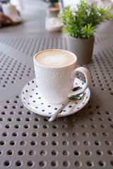 A cup of coffee on the table. Enjoying hot drinks.