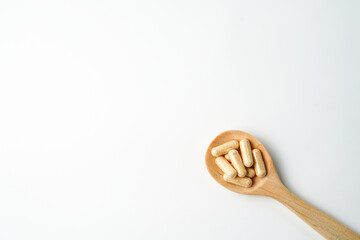 Herbal capsules in wooden spoon, Natural herbs, Alternative Medicine, Herbal supplement