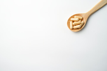 Herbal capsules in wooden spoon, Natural herbs, Alternative Medicine, Herbal supplement