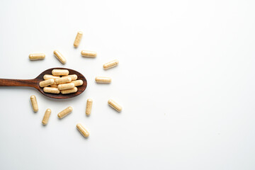 Herbal capsules in wooden spoon, Natural herbs, Alternative Medicine, Herbal supplement