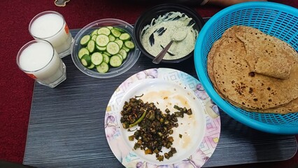 fried ladyfinger salad raita and lassi wheat roti chapatti