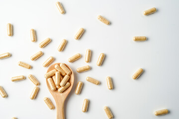 Herbal capsules in wooden spoon, Natural herbs, Alternative Medicine, Herbal supplement