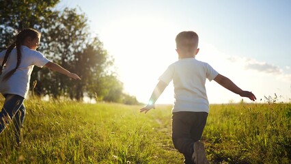 happy family kids. people in the park children child running together in the park at sunset silhouette. mom dad daughter and son are run happy family and little child in summer. dream kids fun run