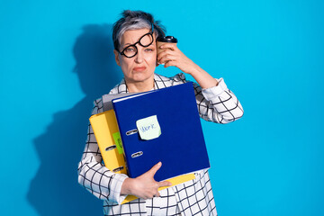 Photo of tired successful senior woman wear white stylish clothes drink latte isolated on blue...