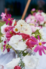 Floral design inspiration and party garden. Assorted flowers in a lush centerpiece arrangement. Romantic setting visuals