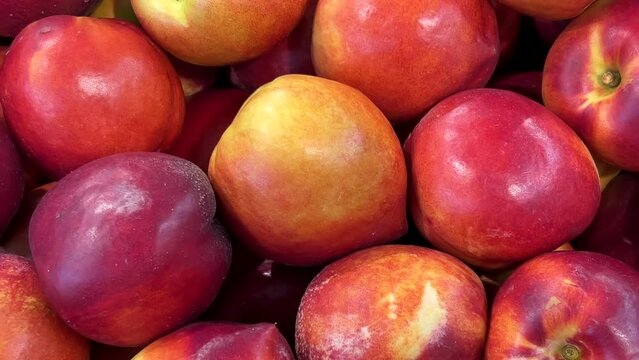Nectarines in view from above, slide shot on the peaches displayed on a fruit stand