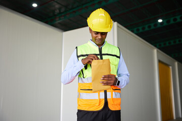 worker counting money from envelope in the factory