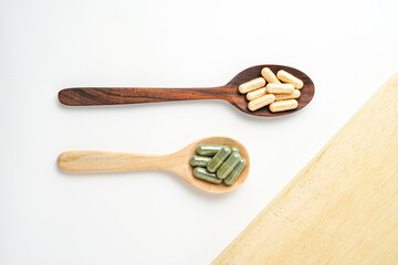 Herbal capsules in wooden spoon, Natural herbs, Alternative Medicine, Herbal supplement
