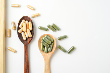 Herbal capsules in wooden spoon, Natural herbs, Alternative Medicine, Herbal supplement