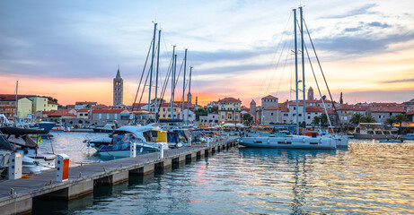 Fototapeta premium Historic town of Rab towers and sailing harbor sunset panoramic view
