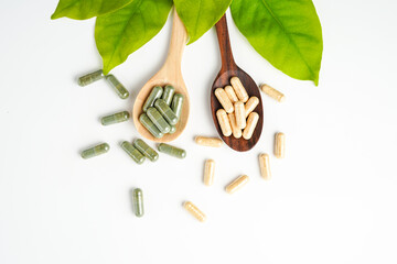Herbal capsules in wooden spoon, Natural herbs, Alternative Medicine, Herbal supplement