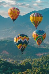 Obraz premium Group of hot air balloons in flight, set against a backdrop of lush green hillside