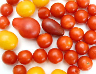 Mini black, red, and yellow tomatoes isolated on white