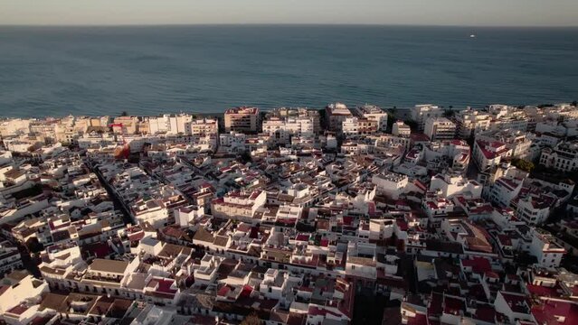 Aerial view of a coastal town with beautiful architecture and ocean in the background
