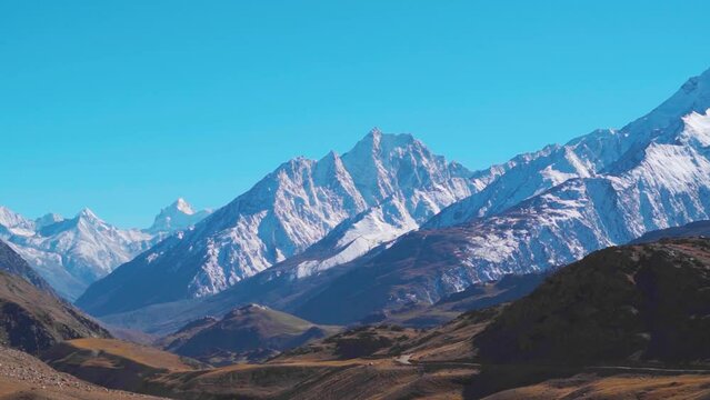 Snowy Himalayan mountain range as seen from Chandra Taal Lake in Spiti Valley, Himachal Pradesh, India. Snow covered Himalayan mountain peaks as seen from the glacial Chandratal lake in Spiti at Noon.