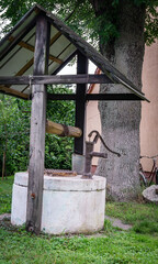 Old Well With Hand Pump In Rural Backyard