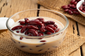 Boiled red beans in coconut milk and sugar in glass bowl,Thai Dessert on wooden table