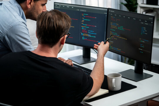 IT developers discussing online software development information on pc screen, creating program coding for latest version application on website. Concept of brainstorming firmware updated. Sellable.
