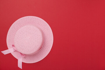 Pink hat on color background, top view. Summer concept