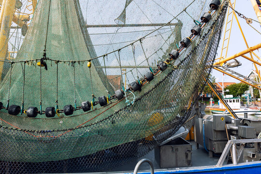 Traditional old german fishing cutter boats moored Neuharlingersiel harbor Wadden sea East Frisia Northern Germany. Commercial fish crab shrimp trawler beam trawl nets North Sea small port city