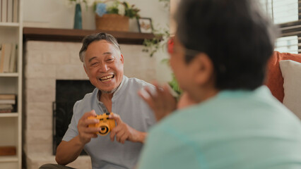 old asian senior couple packing cloth and stuff for a trip together,happiness asian old age retired...
