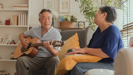 sweet Asian senior Couple sing play acoustic ukulele instrument. Happy Smiling Elderly grandparent having fun and enjoying their Retirement life. Lifestyle, Party happy lifestyle healhy insurance idea