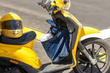 the yellow motorbike of a postman delivering letters. Spanish post