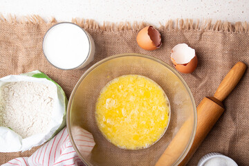 Home Baking - whisking eggs for homemade cake. Recipe with eggs, wholegrain flour, sugar and kefir