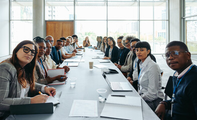 First person view of a big team staff meeting in a modern conference room