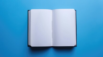 Top view of open notebook on blue background for customization Represents business office or education