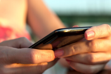 Close up view of woman hands holding a smart phone
