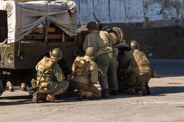 Historical reconstruction. An American infantry soldiers from the World War II  prepare to attack...