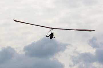 Hang Glider flying in a cloudy sky
