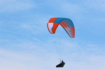  Paraglider flying in a blue sky