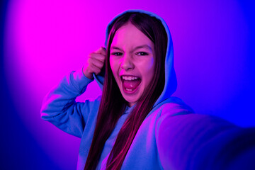 Photo of funky attractive little lady dressed hoodie recording video empty space isolated neon pink color background