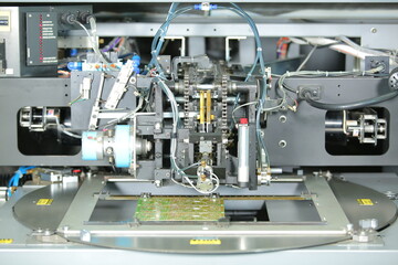 machine making motherboard close up. electronic system manufacturing. computer mother board chip hardware. production process of electronic hardware. circuit board close up circuit board manufacturing