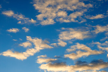 Fototapeta premium Morning, blue sky and clouds with sunshine as background for natural beauty, atmosphere and weather. Wallpaper, sunshine and scenic view in air for environment, heaven and cloudscape in nature