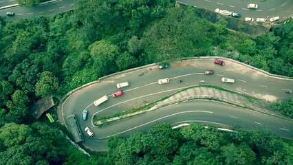 video of cars going in serpentine road hairpin bend in a hill