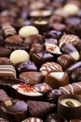 chocolate candy with various fillings, pralines and truffles, sweet food background.