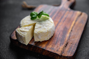 soft cheese cow milk, goat or sheep cheese natural fresh appetizer meal food snack on the table copy space food background rustic top view